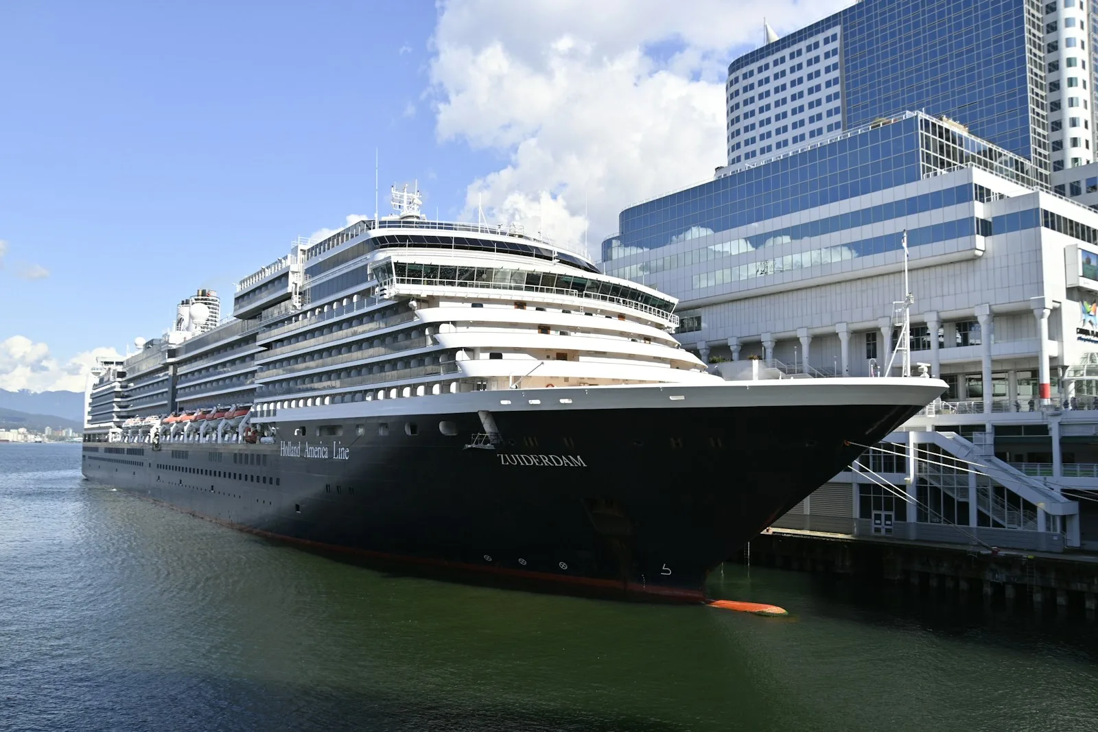 a large cruise ship docked at canada place cruise terminal